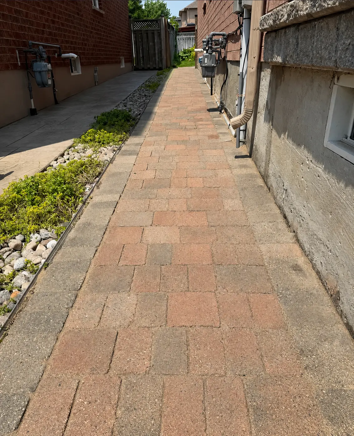 The same interlock paver walkway beside the home, cleaned, sanded and sealed