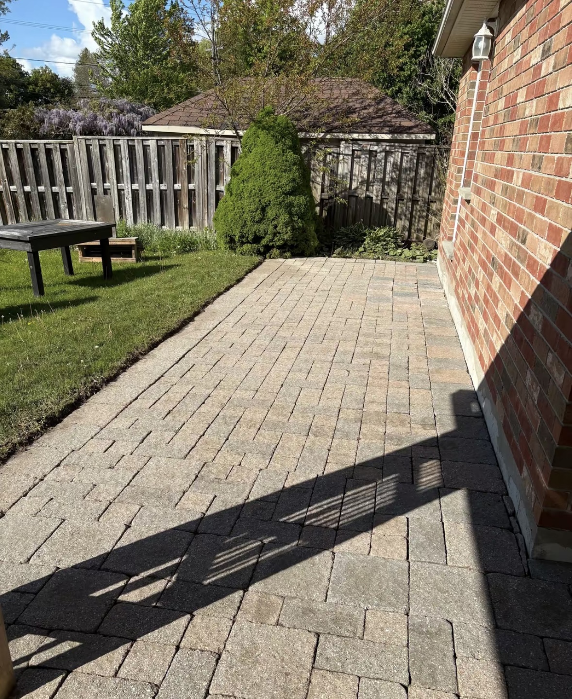 Curved interlock paver walkway between two stone pillars, cleaned, sanded and sealed